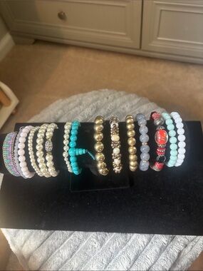 15 bracelets, most are stretchy and are in good condition,